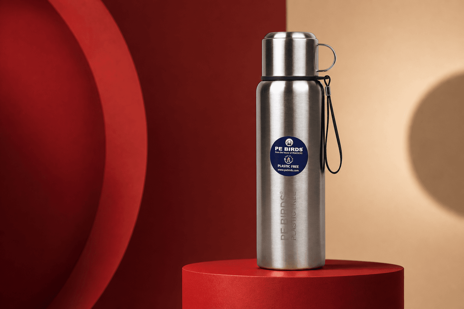 Editorial studio mockup of the PE BIRDS Steel O Steel flask on a red plinth